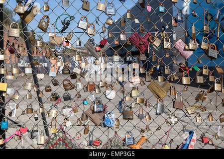 Display of autographed padlocks or love locks on a fence outside Shoreditch High Street overground station, East London. Stock Photo