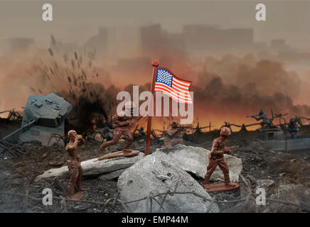 Toy war zone. Plastic toy war scene with soldiers, weapons, explosions, flag and fire. Stock Photo