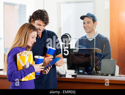 Couple Buying Movie Tickets At Box Office Stock Photo