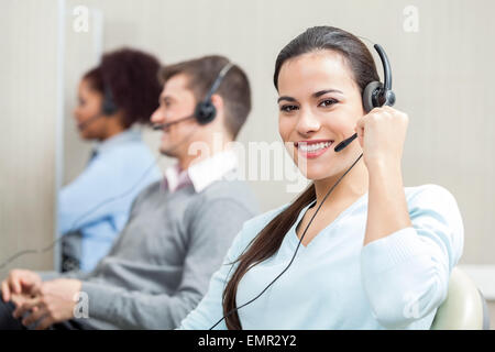 Smiling Female Customer Service Executive Working In Office Stock Photo