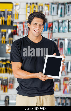 Smiling Man Presenting Digital Tablet In Hardware Store Stock Photo