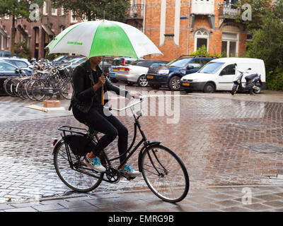 cyclist on the rain in Amsterdam Holland Stock Photo