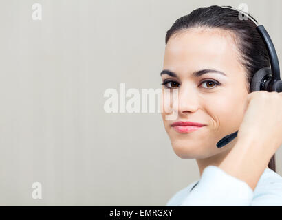 Female Call Center Employee Using Headset Stock Photo