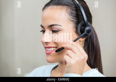 Customer Service Representative Using Headphones Stock Photo
