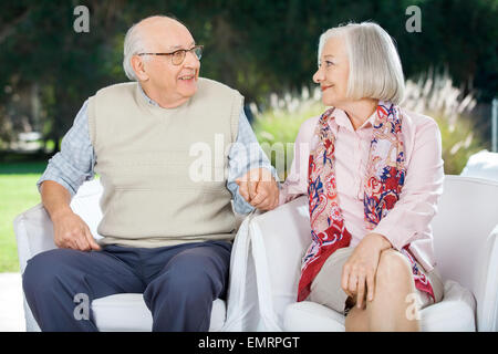 Senior Couple Holding Hands And Looking At Each Other Stock Photo