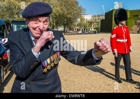 Peter Kent, 90 Royal Navy, show off his boxing skills - Second World War Veterans and serving Guardsmen on Horse Guards Parade Ground to highlight Royal British Legion events on Victory in Europe (VE) Day. The Legion is also announcing that veterans and their carers will receive funding towards attending the event on the weekend of the 8-10th May.  Places will be available for a series of commemorative events over the weekend including on VE Day itself, Friday 8 May, when a Service of Remembrance will be held at The Cenotaph, with a national two min Stock Photo