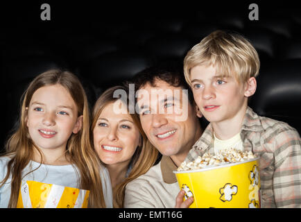 Happy Family Watching Film In Movie Theater Stock Photo