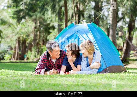Family Relaxing Inside Tent Stock Photo
