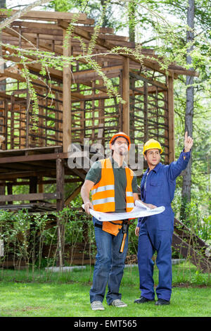 Architect Discussing At Construction Site Stock Photo