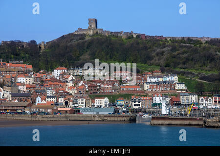 Scarborough Castle on a hillside above the town and harbor - North Yorkshire coast in the northeast of England. Stock Photo