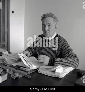 1953, historical picture of English author, novelist, critic, translator and classicist poet, Robert Graves, at his desk, Dela -Soller, Majorca. Stock Photo