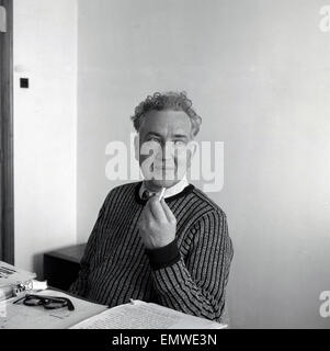 1953 historical picture of English author, novelist, critic, translator and classicist poet, Robert Graves, at his desk, Dela -Soller, Majorca. Stock Photo