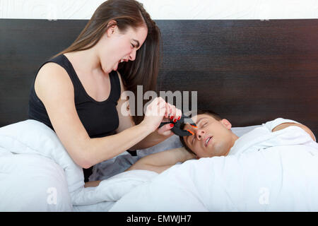 Young girl being angry on snoring boyfriend. Unhappy woman and her snoring husband. I still hear you loud. Person disturbed by s Stock Photo