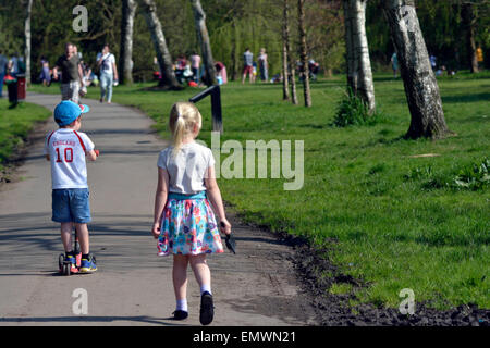 Manchester, UK. 23rd April, 2015. A young boy wearing an England shirt on St George's Day rides his scooter in Fletcher Moss Park in Didsbury, South Manchester. UK Weather Temperature soars in Manchester  UK. Credit:  John Fryer/Alamy Live News Stock Photo