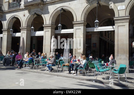 People sitting at outdoor cafe restaurant in the sunshine in Plaza Real, Barcelona, Catalonia, Spain Stock Photo