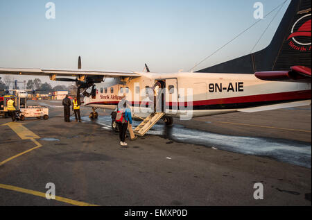 Passengers boarding a Simrik Airlines airplane from Kathmandu to Lukla, in Nepal Stock Photo