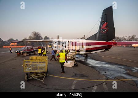 Loading Luggage on a Simrik Airlines airplane from Kathmandu to Lukla, in Nepal Stock Photo