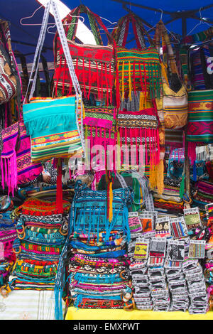 Brightly colored fabrics on display for sale at Otavalo market, Ecuador Stock Photo