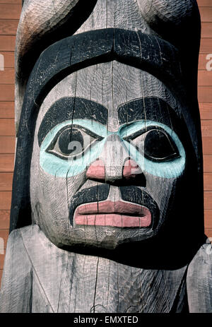 The face of the Spirit Man is the bottom figure on this Native Alaska totem pole that can be seen in Juneau, the state capital of Alaska, USA. Sculpted by master Tlingit carver Nathan Johnson, the towering Wooshkeetaan totem was erected in 1981 outside Centennial Hall and the Visitors Center. Stock Photo