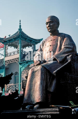 A setting sun casts shadows on Dr. Sun Yat-sen, founding father of the Republic of China (ROC), who is honored with this monument in downtown Los Angeles, California, USA. Crafted in Taiwan, the painted sculpture was unveiled in the Central Plaza of L.A.'s Chinatown in 1966, 100 years after Sun Yat-sen's birth. Stock Photo