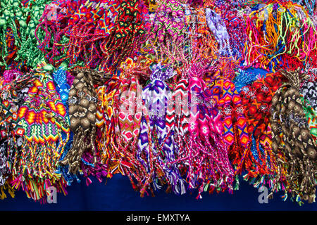 Brightly colored jewelry on display at Otavalo market, Ecuador Stock Photo