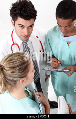 A team of medical professionals conferring Stock Photo