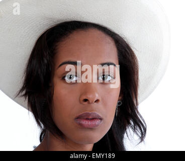 Serious looking African American woman wearing a white cowboy hat.