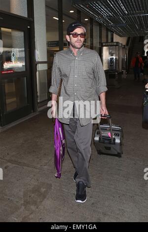 A dishevelled Luke Perry sporting a scruffy stubble arrives in Los Angeles at LAX carrying a framed picture under his arm  Featuring: Luke Perry Where: Los Angeles, California, United States When: 19 Oct 2014 Stock Photo