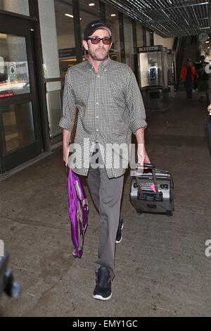 A dishevelled Luke Perry sporting a scruffy stubble arrives in Los Angeles at LAX carrying a framed picture under his arm  Featuring: Luke Perry Where: Los Angeles, California, United States When: 19 Oct 2014 Stock Photo