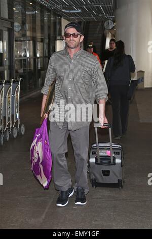 A dishevelled Luke Perry sporting a scruffy stubble arrives in Los Angeles at LAX carrying a framed picture under his arm  Featuring: Luke Perry Where: Los Angeles, California, United States When: 19 Oct 2014 Stock Photo