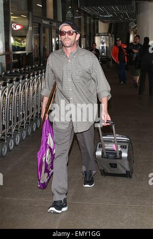 A dishevelled Luke Perry sporting a scruffy stubble arrives in Los Angeles at LAX carrying a framed picture under his arm  Featuring: Luke Perry Where: Los Angeles, California, United States When: 19 Oct 2014 Stock Photo