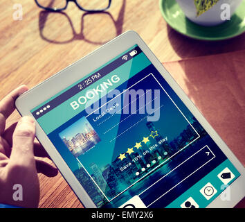 Man Booking Hotel Reservation on Digital Tablet Stock Photo