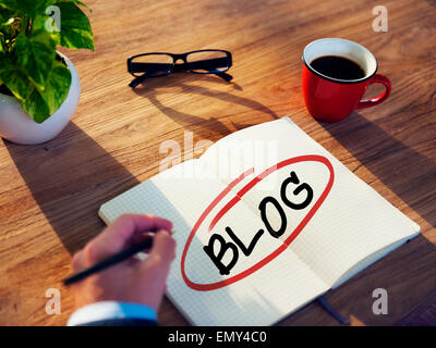 Man with a Note Pad and Blog Concepts Stock Photo