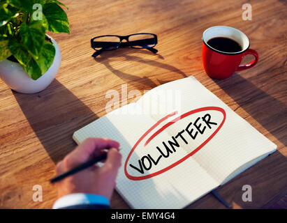 Man with Note Pad and Volunteer Concept Stock Photo