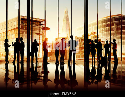 Sepia Toned Picture Of Silhouettes Of Multi-Ethnic Group Of Business People Working Together Indoors Stock Photo