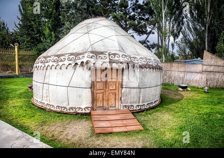 Urta nomadic house on the green grass in Ruh Ordo complex near Issyk Kul lake, Kyrgyzstan Stock Photo