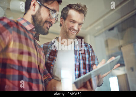 Modern businessmen with touchpad working with electronic documents Stock Photo
