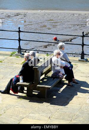 Pensioners sitting on benches on whitby sea front,North Yorkshire,England,UK Stock Photo