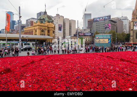 Melbourne, Australia. 24 April 2015. A sea of handmade red poppies in Federation Square ahead of ANZAC Day centenary commemorations on 25 April. Two years ago, Lynn Berry and Margaret Knight started a community-based project to encourage people to 5000 crochet poppies to mark the centenary of the Gallipoli landings. An estimated 50,000 contributors made 250,000 poppies and are currently in Federation Square before being moved onto the Princes Bridge for Anzac Day. Credit:  Kerin Forstmanis/Alamy Live News Stock Photo