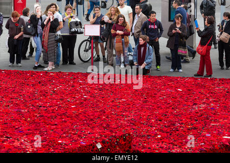 Melbourne, Australia. 24 April 2015. A sea of handmade red poppies in Federation Square ahead of ANZAC Day centenary commemorations on 25 April. Two years ago, Lynn Berry and Margaret Knight started a community-based project to encourage people to 5000 crochet poppies to mark the centenary of the Gallipoli landings. An estimated 50,000 contributors made 250,000 poppies and are currently in Federation Square before being moved onto the Princes Bridge for Anzac Day. Credit:  Kerin Forstmanis/Alamy Live News Stock Photo