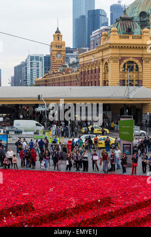 Melbourne, Australia. 24 April 2015. A sea of handmade red poppies in Federation Square ahead of ANZAC Day centenary commemorations on 25 April. Two years ago, Lynn Berry and Margaret Knight started a community-based project to encourage people to 5000 crochet poppies to mark the centenary of the Gallipoli landings. An estimated 50,000 contributors made 250,000 poppies and are currently in Federation Square before being moved onto the Princes Bridge for Anzac Day. Credit:  Kerin Forstmanis/Alamy Live News Stock Photo