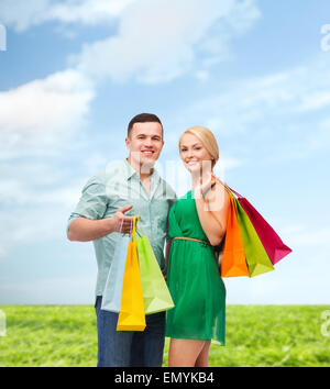 smiling couple with shopping bags Stock Photo