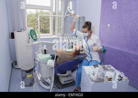 The doctor the dentist starts to work with the patient in a stomatologic office. Stock Photo