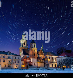 Star trails over the Royal Cathedral on Wawel Hill within the grounds of Wawel Castle in Krakow in Poland. The cathedral feature Stock Photo