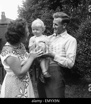 Manchester City footballer Don Revie pictured with his son Duncan and wife in the back garden of the family home. 4th August 1955. Stock Photo