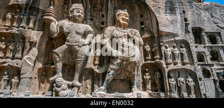 Carved Buddha images at Longmen Caves, Dragon Gate Grottoes, dating from the 6th to 8th Centuries, UNESCO World Heritage Site. Stock Photo