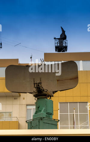 Military style disused radar on a building with blue skies Stock Photo