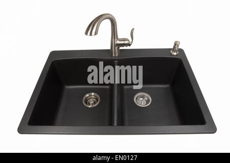 Modern kitchen sink made of black synthetic granite with brushed stainless steel faucet and soap dispenser.  Isolated on white. Stock Photo