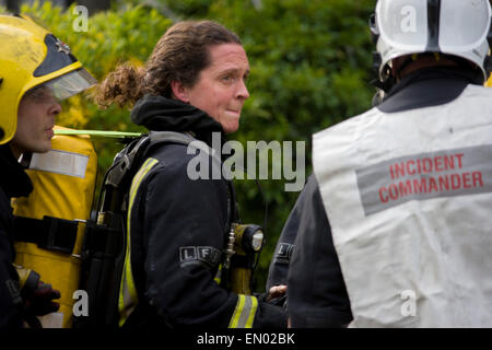 Female London Fire Brigade (LFB) firefighter attend a roof fire in Herne Hill, south London. s Stock Photo