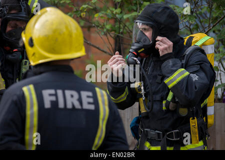 London Fire Brigade (LFB) firefighters attend a roof fire in Herne Hill, south London. Stock Photo